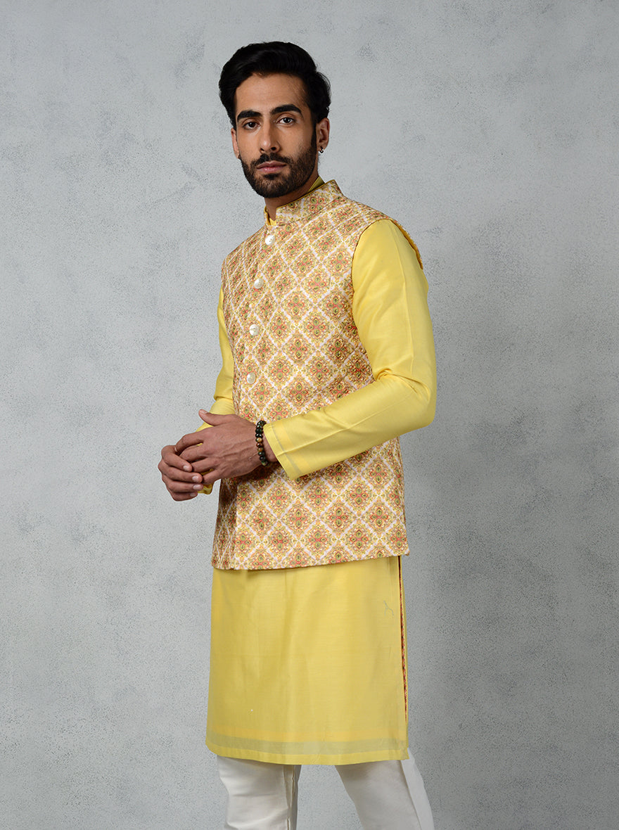 Bright yellow bandhgala for men, made from silk with geometric prints and thread embroidery, ideal for festive occasions like Haldi.