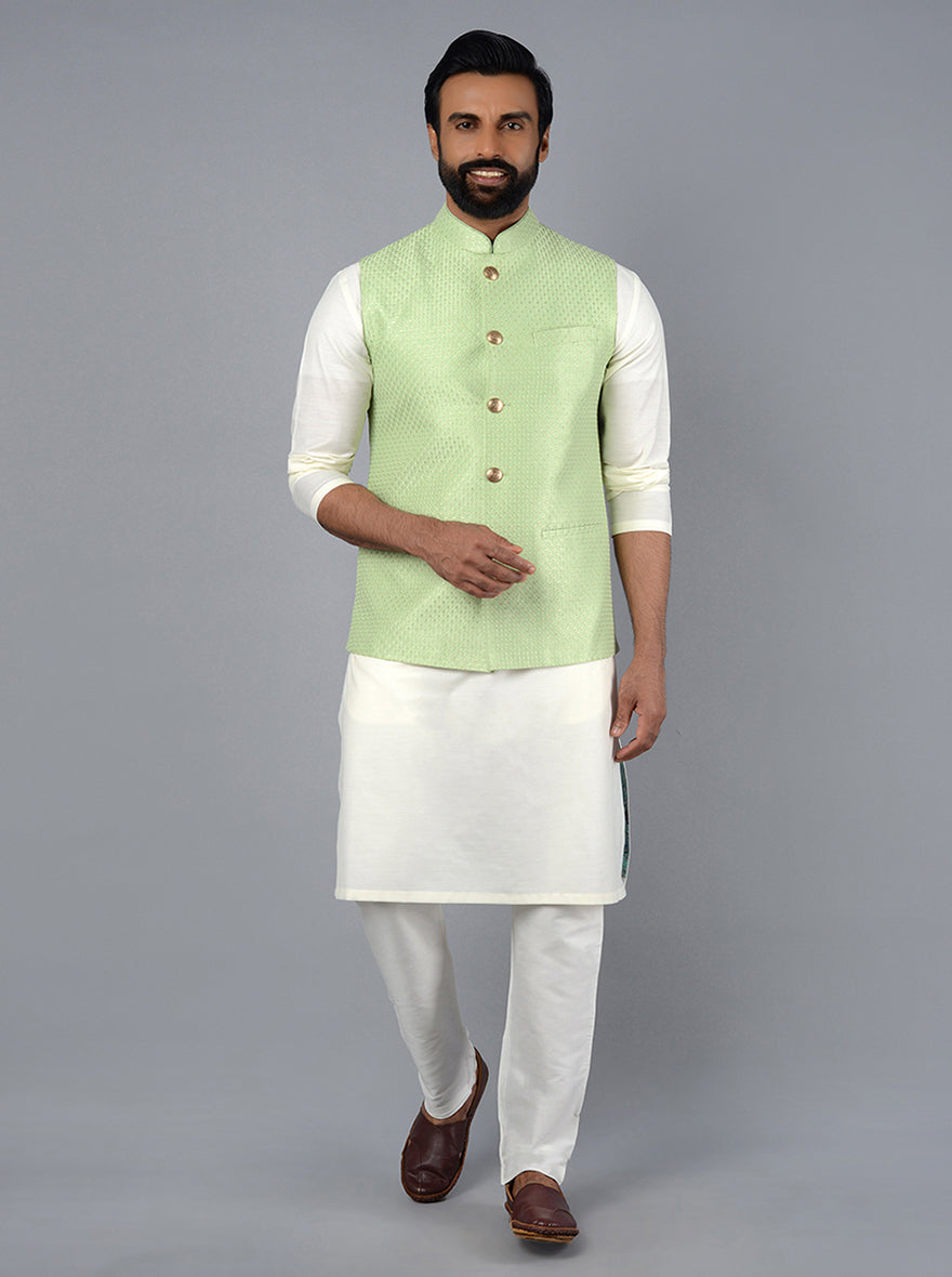 This tea green Bandhgala for men features a silk blend fabric, straight-fit design, and elegant embroidery, perfect for mehndi functions and formal occasions.