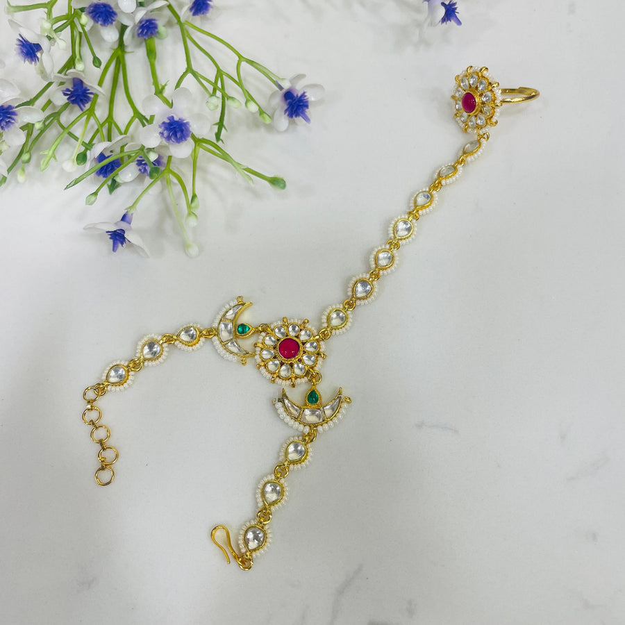 Stunning Kundan hand chain adorned with intricate gemstones, perfect for festive occasions.