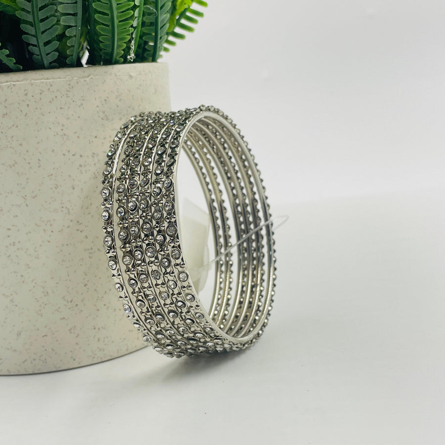 Intricate silver bangle with delicate engravings, adding a touch of sophistication to any outfit.