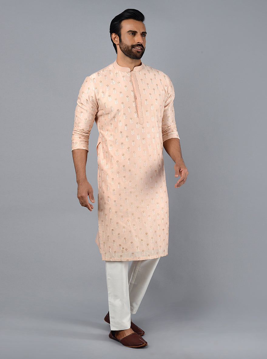 Elevate your ethnic wardrobe with this fashionable Peach Kurta Set for men.