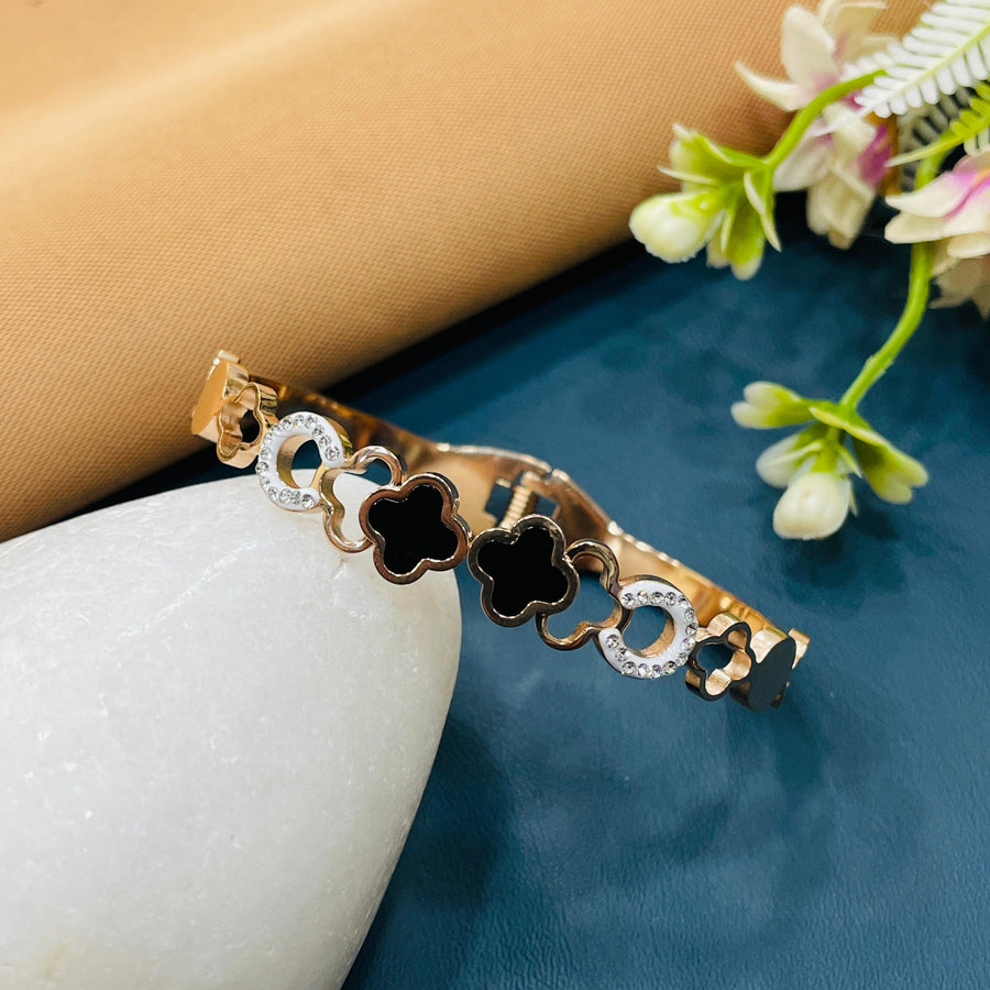 Dainty rose gold bracelet with a star charm, perfect for layering with other pieces.