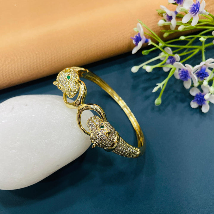 Golden bracelet with a bold, statement cuff design, perfect for evening events.