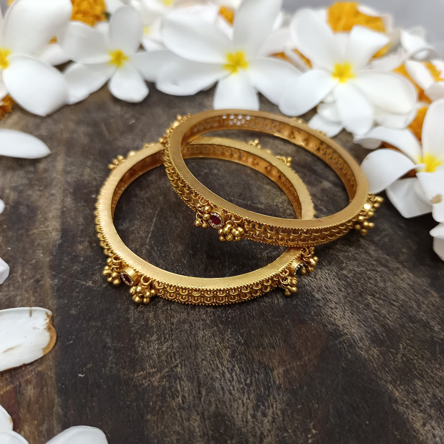 Dainty golden bangles that add a delicate touch to your jewelry collection.