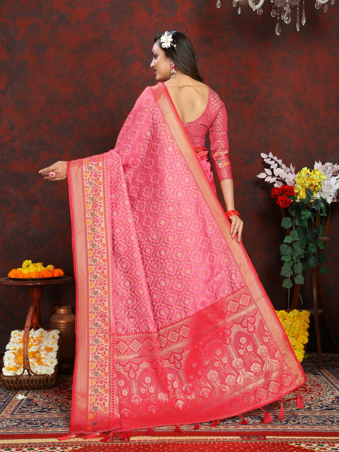 Timeless coral pink organza silk saree with zari border and Meenakari detailing, designed for special celebrations.