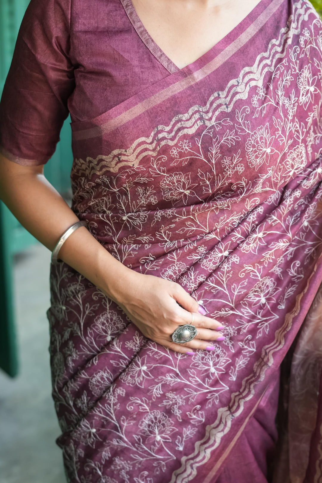 Stunning wine Tussar silk saree featuring a beautiful batik border and decorative tassels, ideal for celebrations.