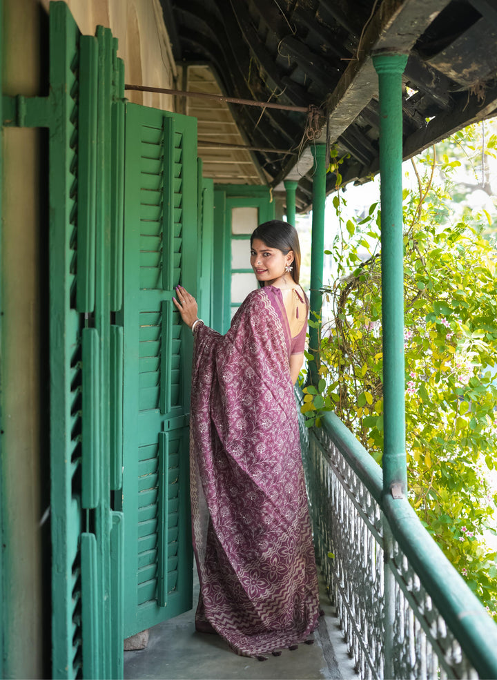 Gorgeous wine Tussar silk saree with intricate batik work and fancy tassels, perfect for traditional events.