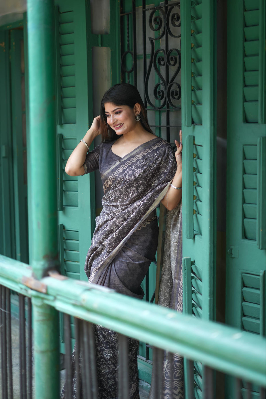 Elegant gray Tussar silk saree featuring intricate batik border design and fancy tassels, perfect for festive events.