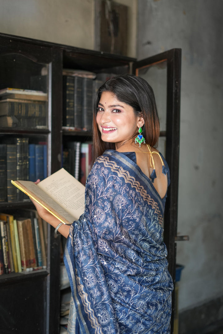 Regal blue Tussar silk saree with batik border and fancy tassels, perfect for festive occasions and weddings.