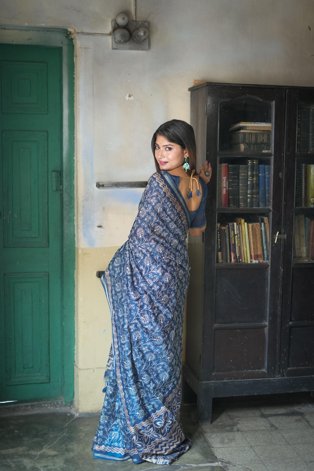 Stunning blue Tussar silk saree with beautiful batik border and decorative tassels, ideal for traditional celebrations.