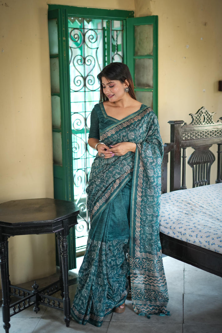 Lovely blue Tussar silk saree with intricate batik border and elegant tassels, perfect for cultural gatherings.