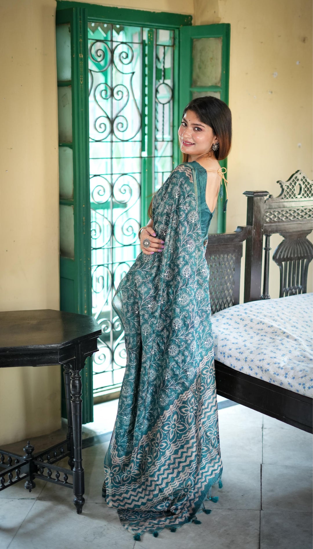 Elegant green Tussar silk saree with batik border and fancy tassels, ideal for festive occasions and cultural events.