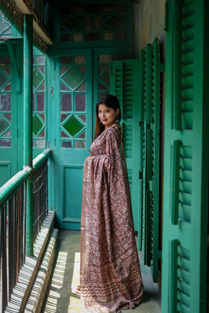 Stunning green Tussar silk saree with intricate batik border and decorative tassels, ideal for traditional wear.