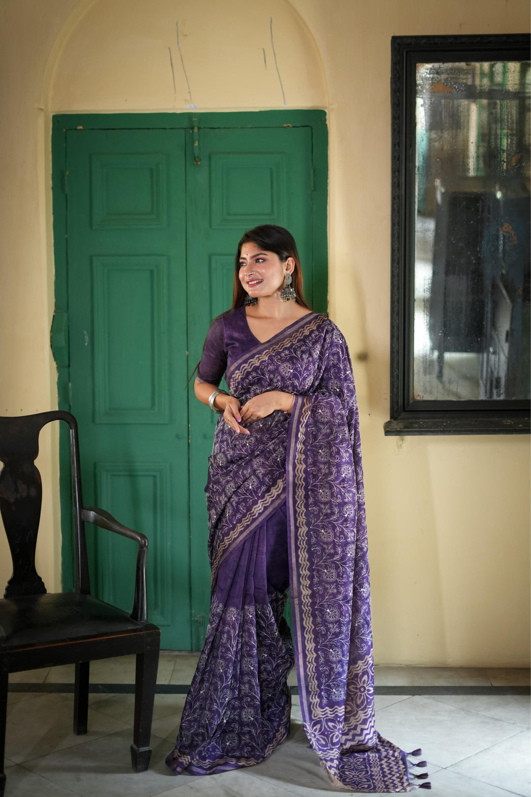 Stunning brown Tussar silk saree featuring intricate batik border and fancy tassels, perfect for cultural gatherings.