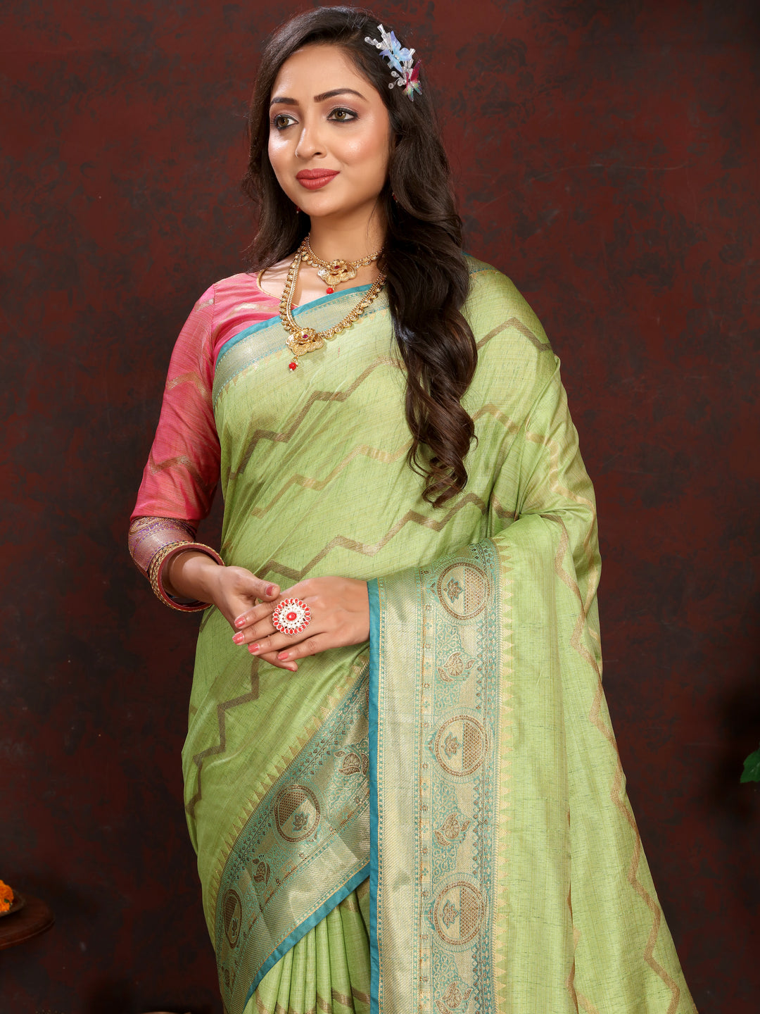 Traditional pista-green silk saree with intricate zari weaving, perfect for festive gatherings.