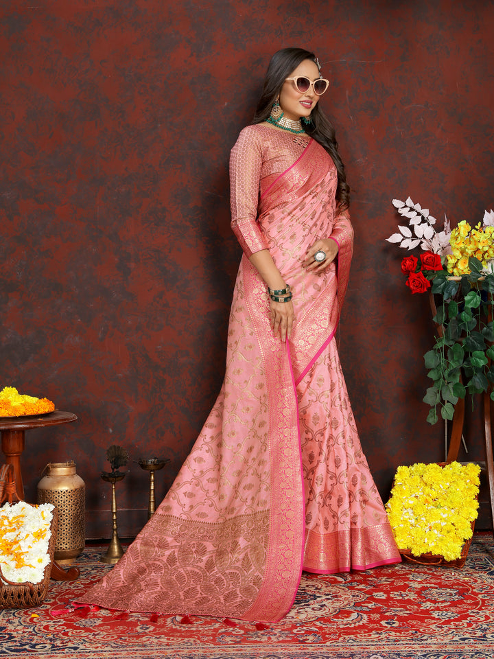 Graceful pink Katan silk saree with beautiful zari design and rich tassels on the pallu, perfect for formal events.