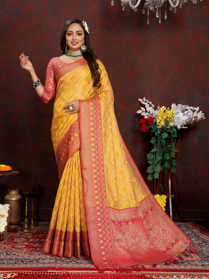 Elegant yellow Organza silk saree with zari weaving and Meenakari pallu, perfect for festive occasions.