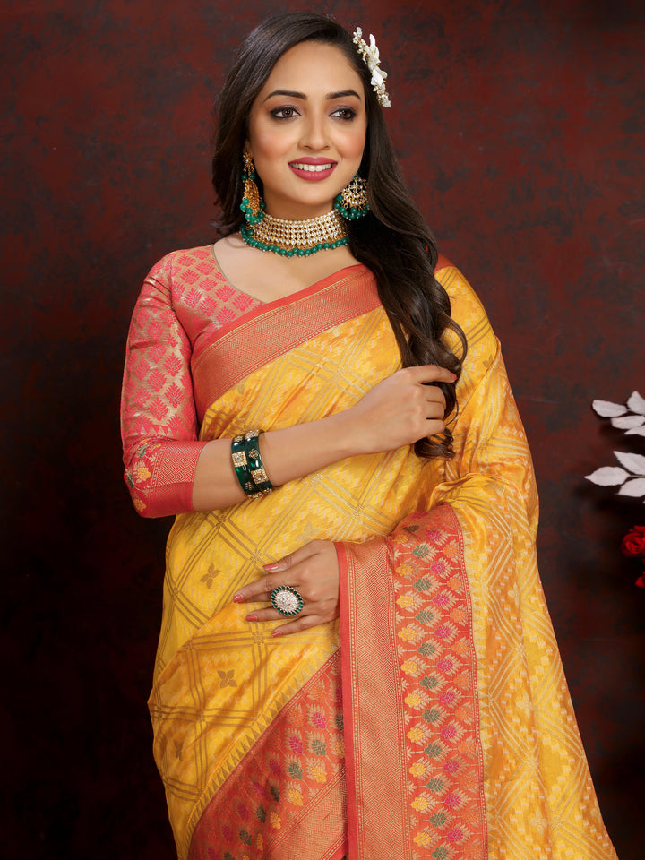 Yellow Organza silk saree featuring luxurious zari and intricate Meenakari pallu, ideal for grand events.