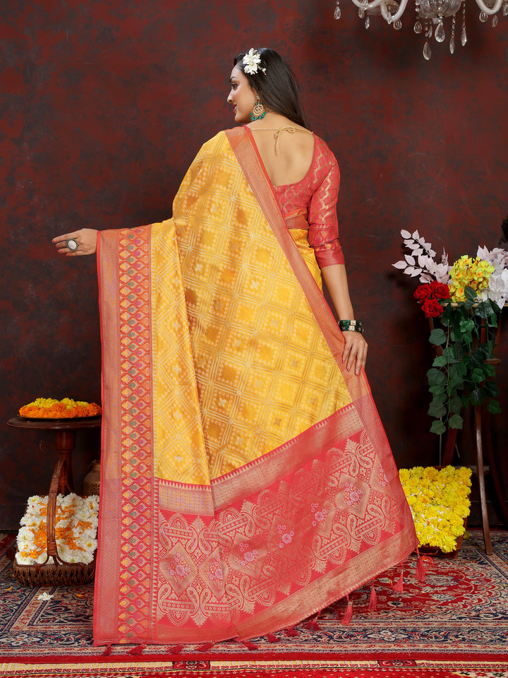 Sophisticated yellow Organza silk saree with Meenakari pallu and zari design, ideal for Indian celebrations.