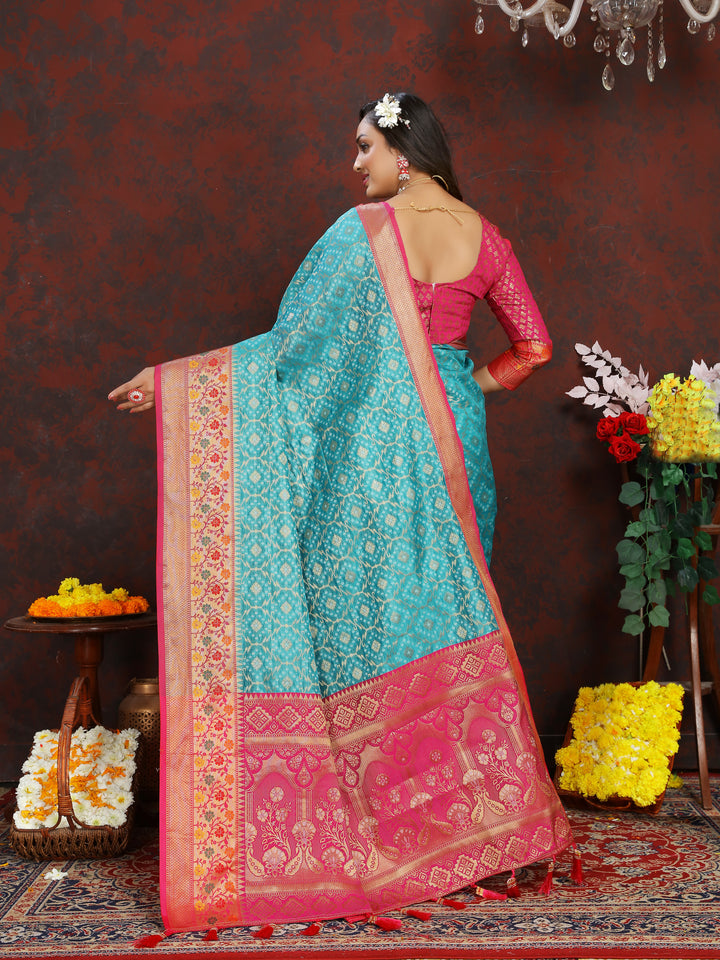 Timeless turquoise saree with Meenakari detailing, zari border, and tassels at the pallu, ideal for special occasions.