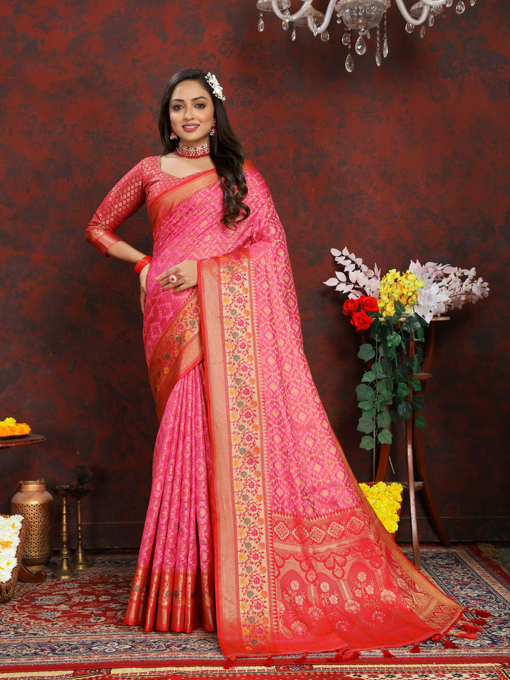 Exquisite pink Meenakari organza silk saree with a zari border and tassels at the pallu, perfect for weddings.