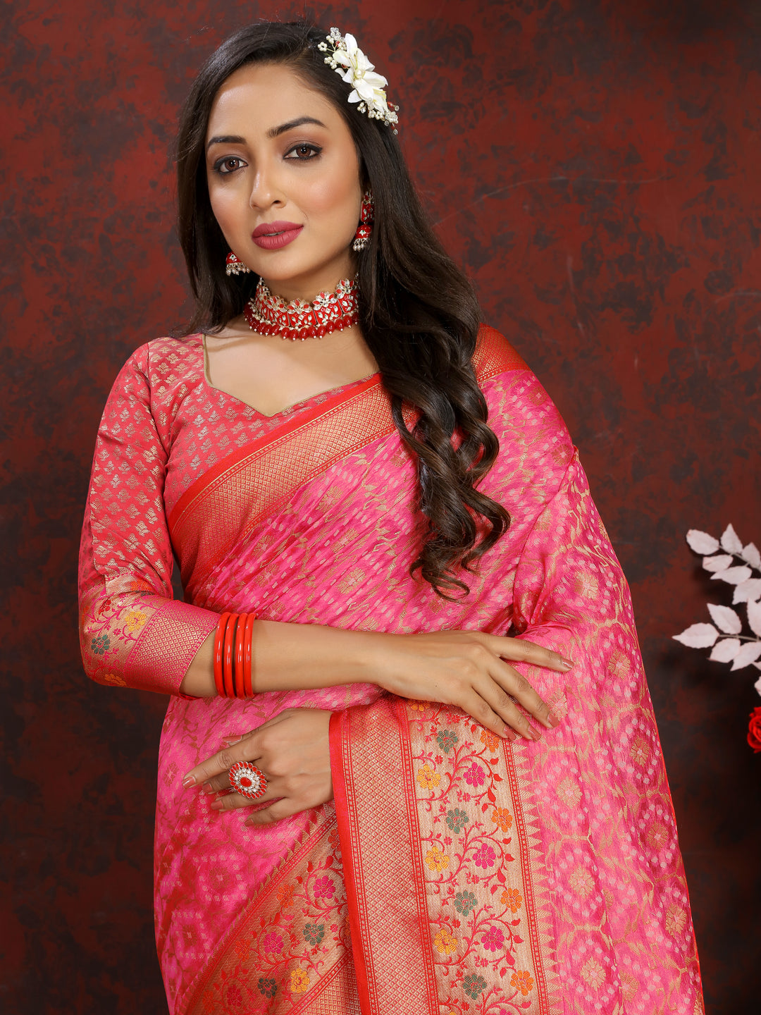 Beautiful pink saree in Meenakari organza silk with a zari border, tassels at the pallu, and delicate detailing.