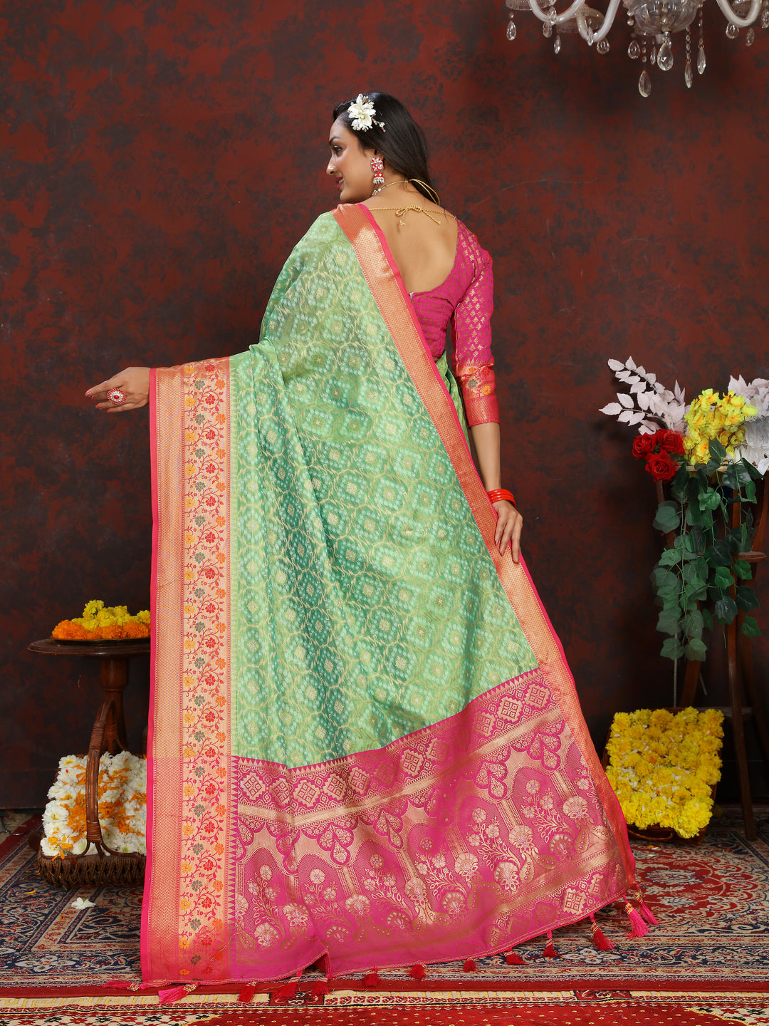 Elegant pista green saree with Meenakari weaving and a zari border, finished with tassels at the pallu.