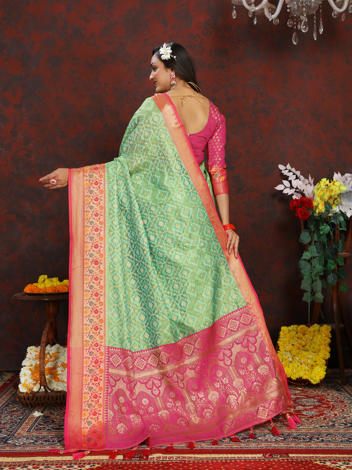 Elegant pista green saree with Meenakari weaving and a zari border, finished with tassels at the pallu.