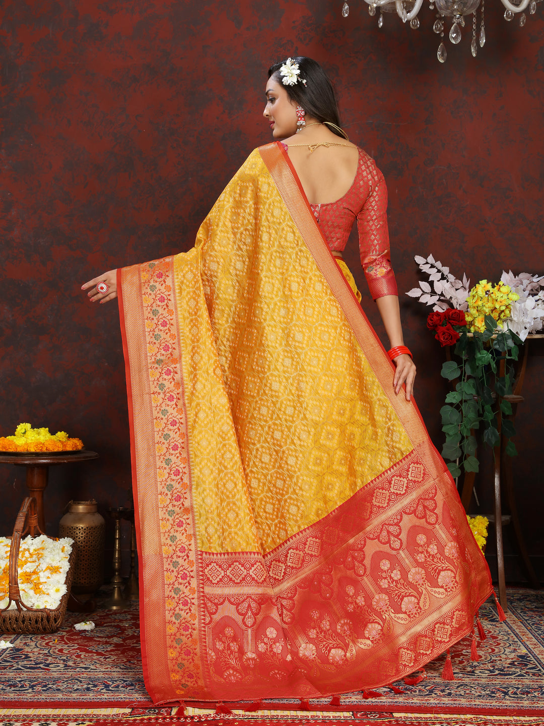 Stunning yellow saree with Meenakari detailing, zari border, and tassels at the pallu, ideal for elegant gatherings.