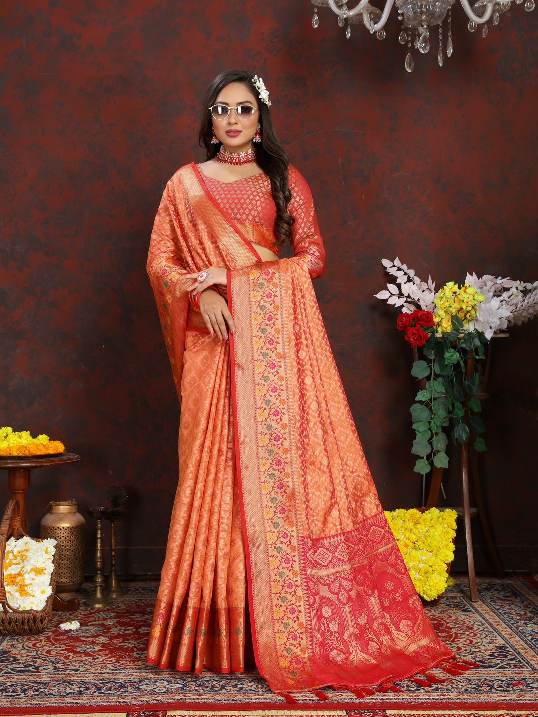 Stunning orange saree in Meenakari organza silk, featuring intricate zari work and tassels at the pallu.