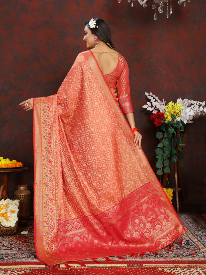 Timeless orange Meenakari organza silk saree with zari detailing and tassels at the pallu, perfect for festive occasions.