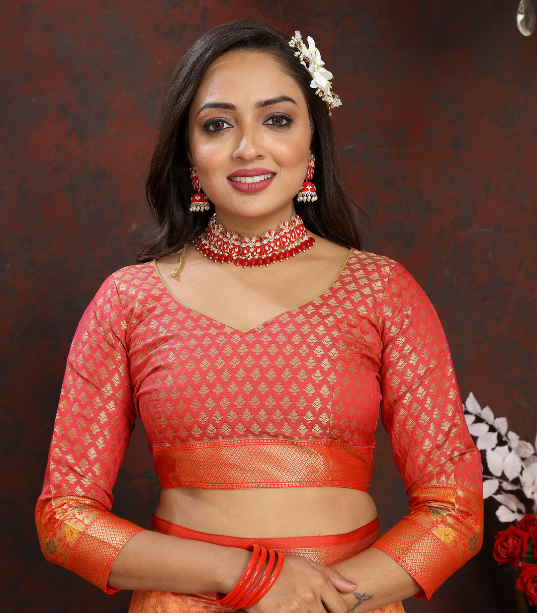 Gorgeous orange Meenakari organza silk saree with intricate zari border and tassels, ideal for special events.