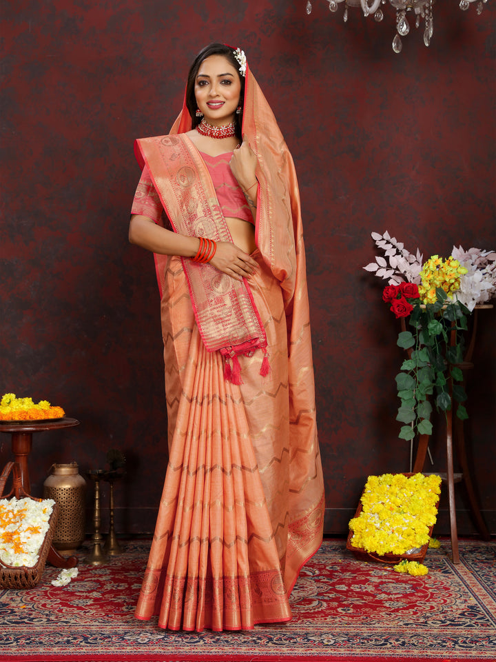 Designer orange silk saree with beautiful zari weaving, ideal for bridal celebrations.