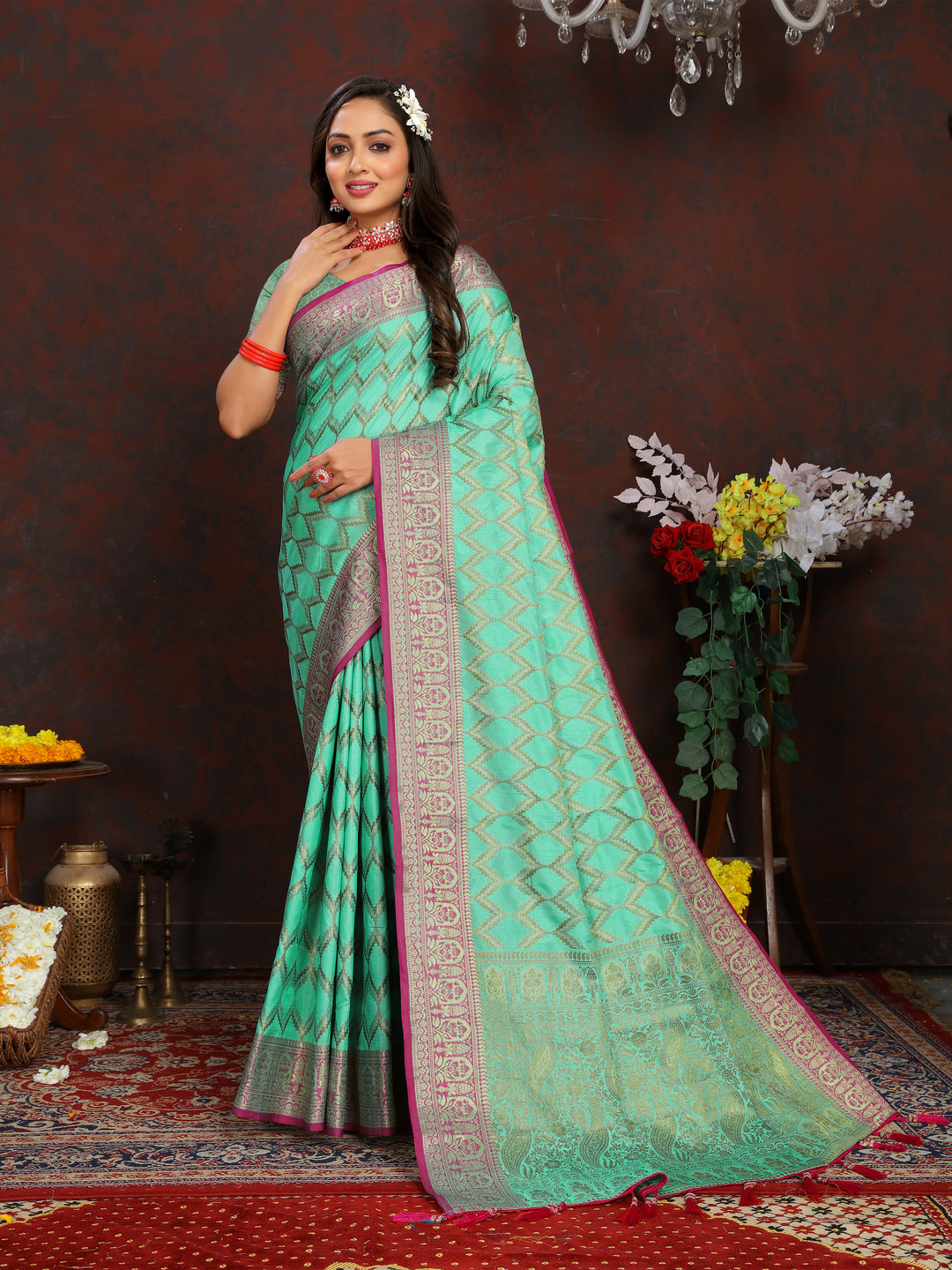 Designer teal-green silk saree with intricate zari work, perfect for traditional events.