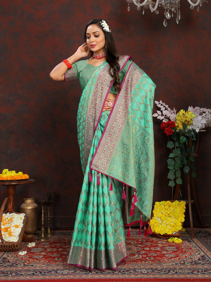 Teal-green silk saree featuring beautiful zari weaving, ideal for bridal and cultural celebrations.