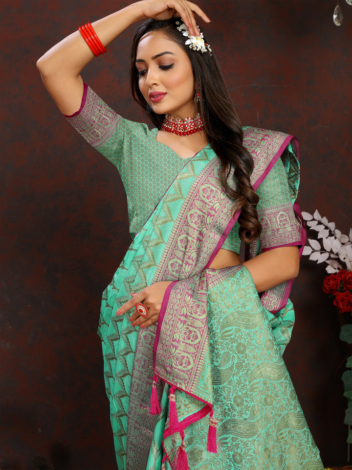 Luxurious teal-green Katan silk saree with detailed zari work, perfect for festive occasions.