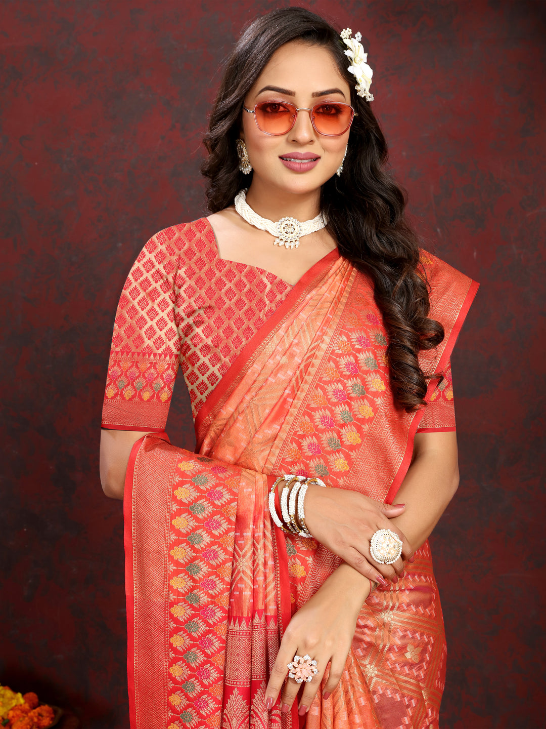 Classic orange Organza silk saree with Meenakari pallu and zari detail, ideal for cultural gatherings.