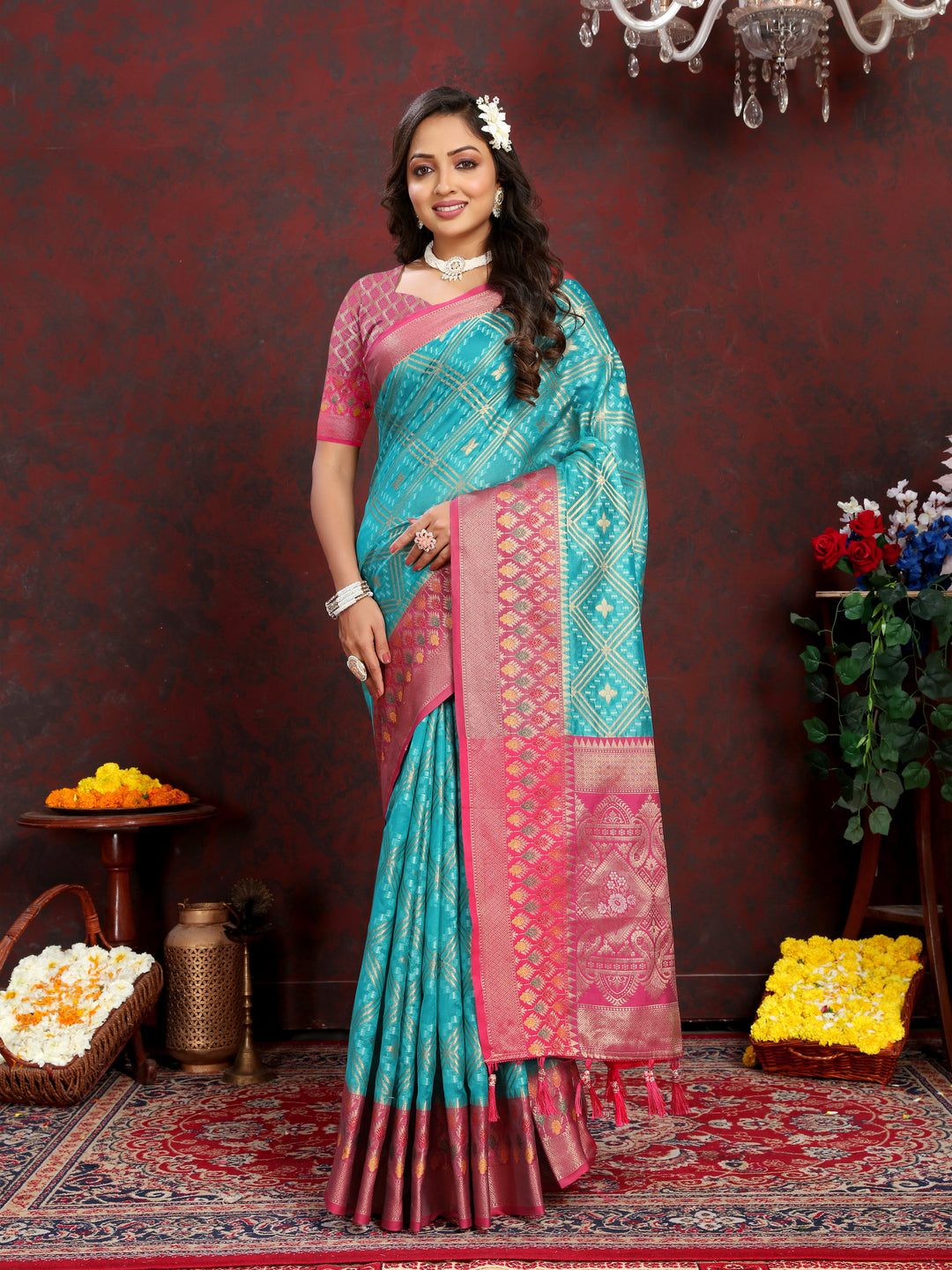 Turquoise Organza silk saree with zari weaving and stunning Meenakari pallu, perfect for celebrations.