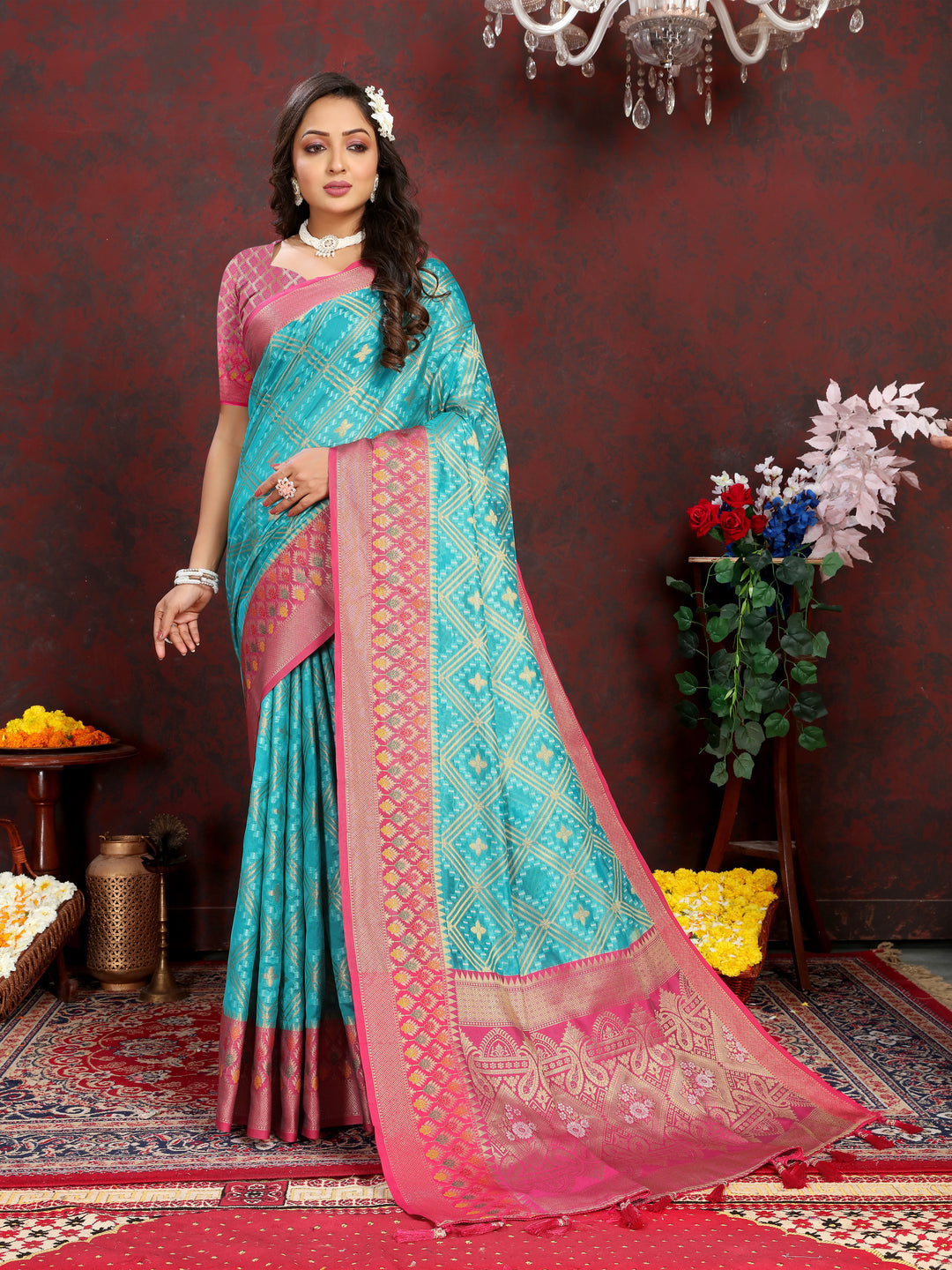 Elegant turquoise Organza silk saree featuring luxurious zari and Meenakari pallu, ideal for grand gatherings.