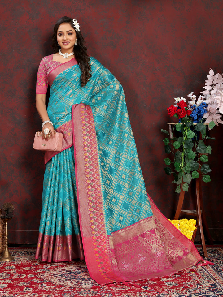 Designer turquoise Meenakari Organza silk saree with rich zari detail, perfect for weddings.