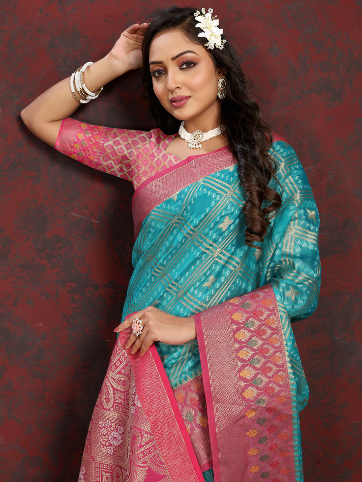 Classic turquoise Organza silk saree with Meenakari pallu and intricate zari design, ideal for festive events.