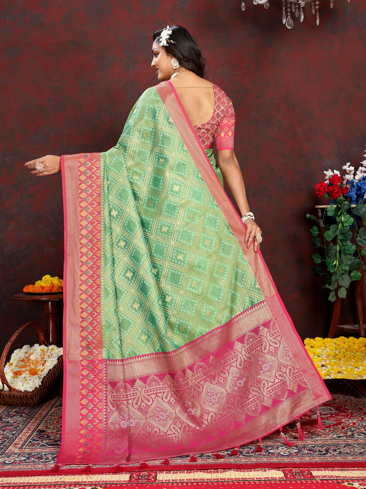 Pista green Organza silk saree featuring luxurious zari and Meenakari design, ideal for Indian ceremonies.