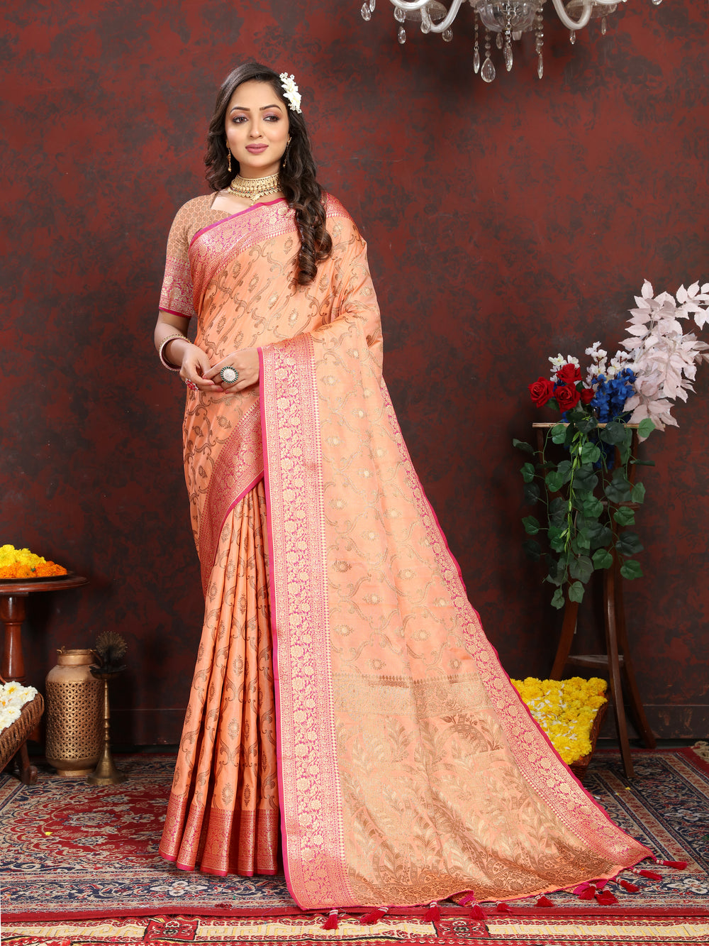 Traditional peach Katan silk saree featuring a matching zari border with tassels and coordinating blouse piece.