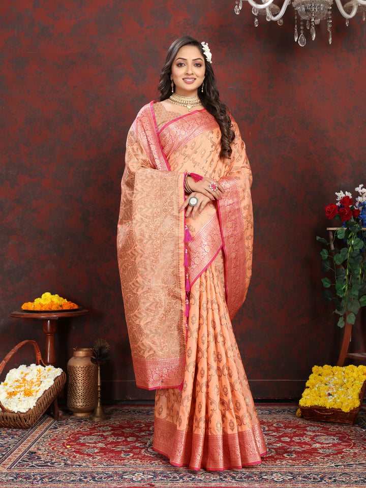 Graceful peach Katan silk saree with exquisite zari weaving and a tassel-adorned pallu, ideal for special occasions.