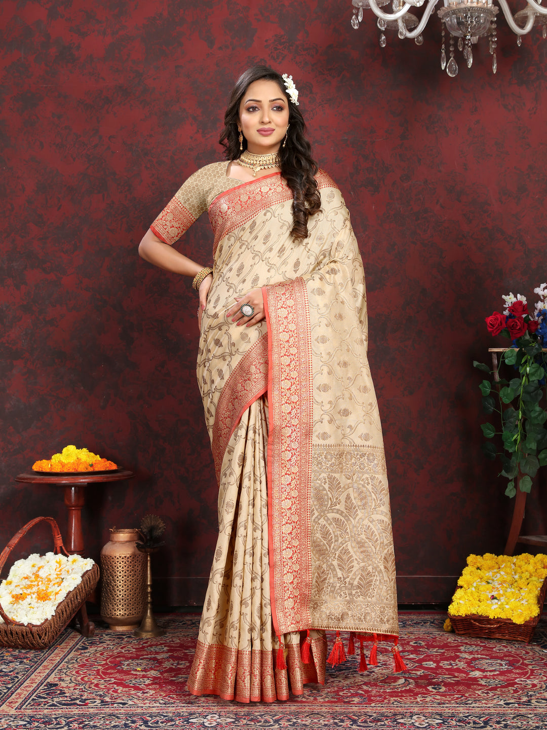 Classic beige Katan silk saree with intricate zari weaving, tassels at the pallu, and matching silk blouse piece.