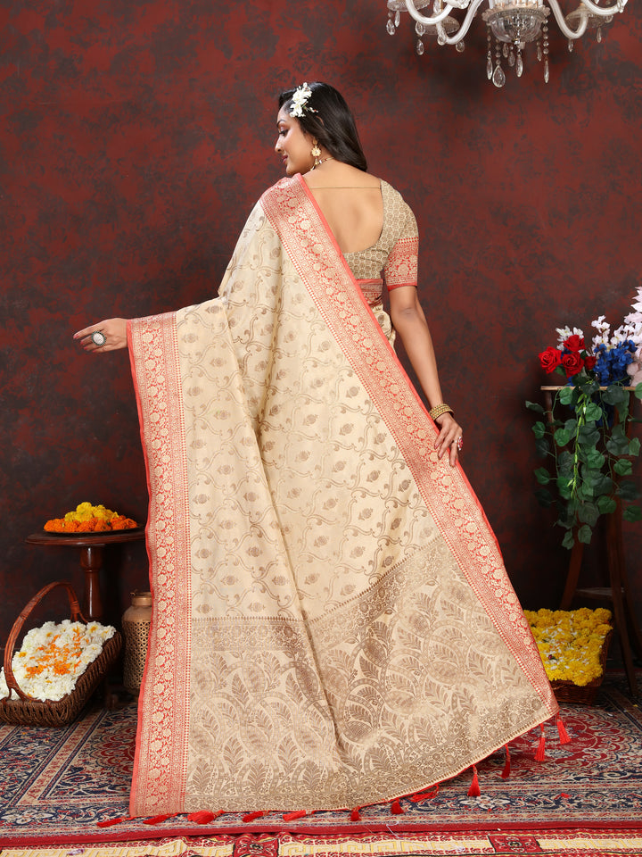 Graceful beige Katan silk saree with zari details and tassels at the pallu, a stunning choice for formal events.