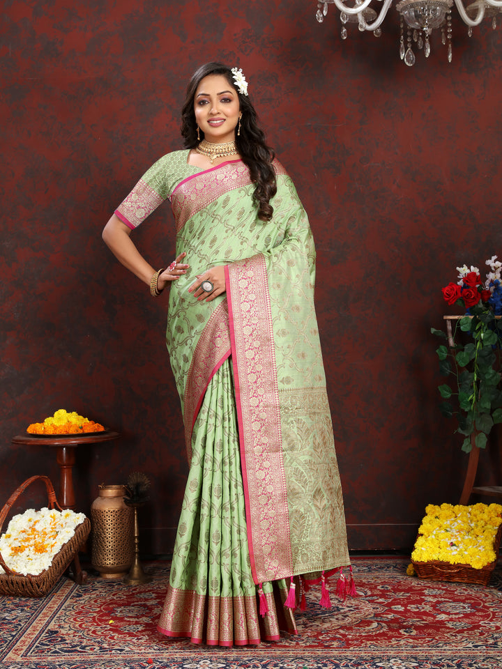 Exquisite green Katan silk saree with intricate zari weaving and tassels on the pallu, perfect for weddings.