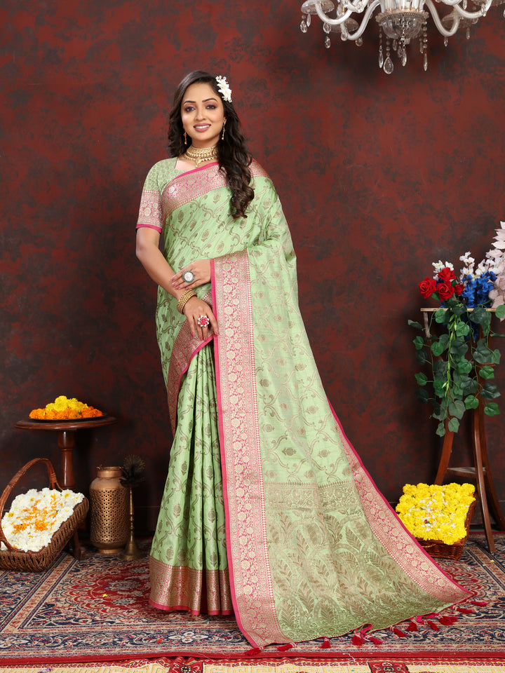 Elegant green Katan silk saree with rich zari work, zari border, and tassels, a timeless choice for festive occasions.