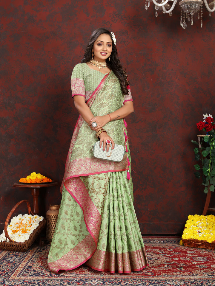 Beautiful green Katan silk saree with detailed zari design and coordinating blouse piece, ideal for celebrations.