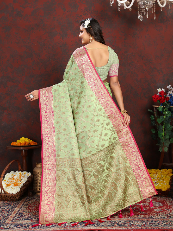 Graceful green Katan silk saree with intricate zari pallu and tassels, designed for special occasions and celebrations.